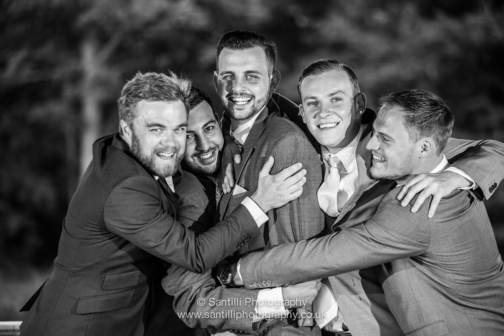The grooms party giving the groom a big congratulatory hug